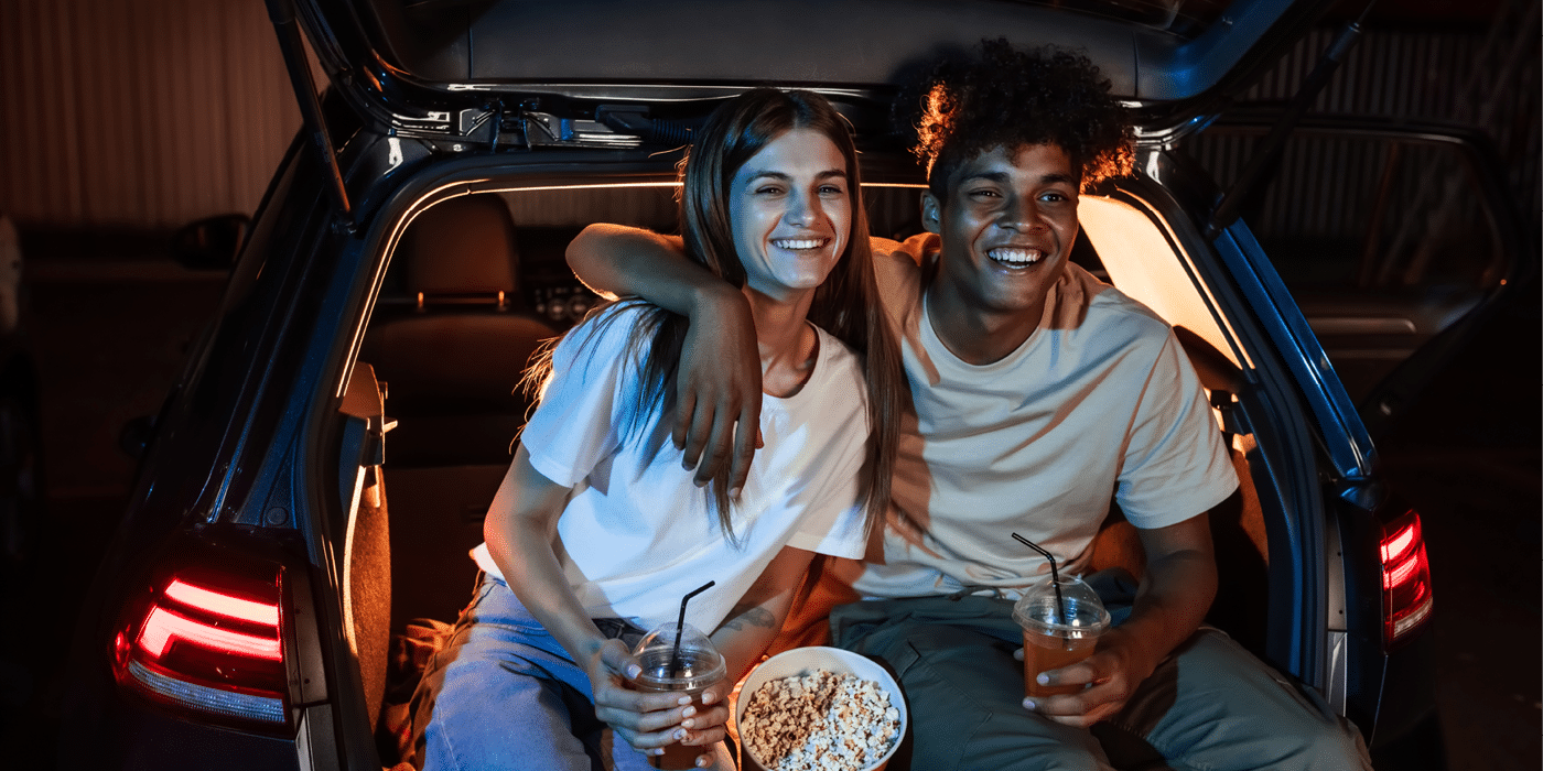 Boy and girl watching a drive in movie.